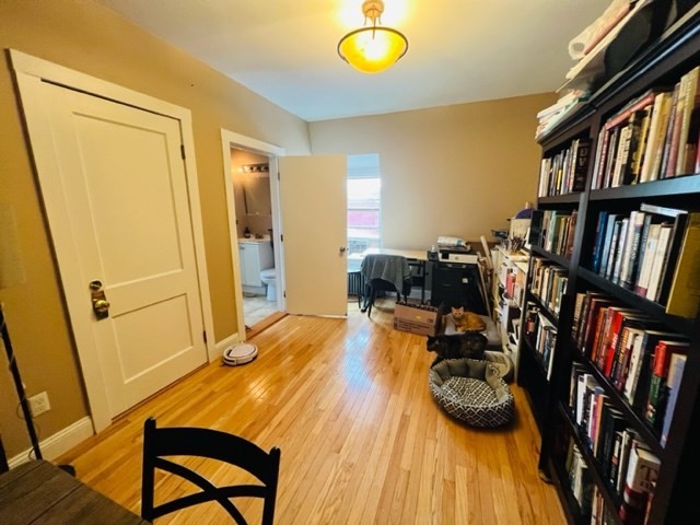 9 Rice Street, Unit 5 Brookline, MA 02445 - Photo 6 of 8 a view of a dining room with furniture and a book shelf