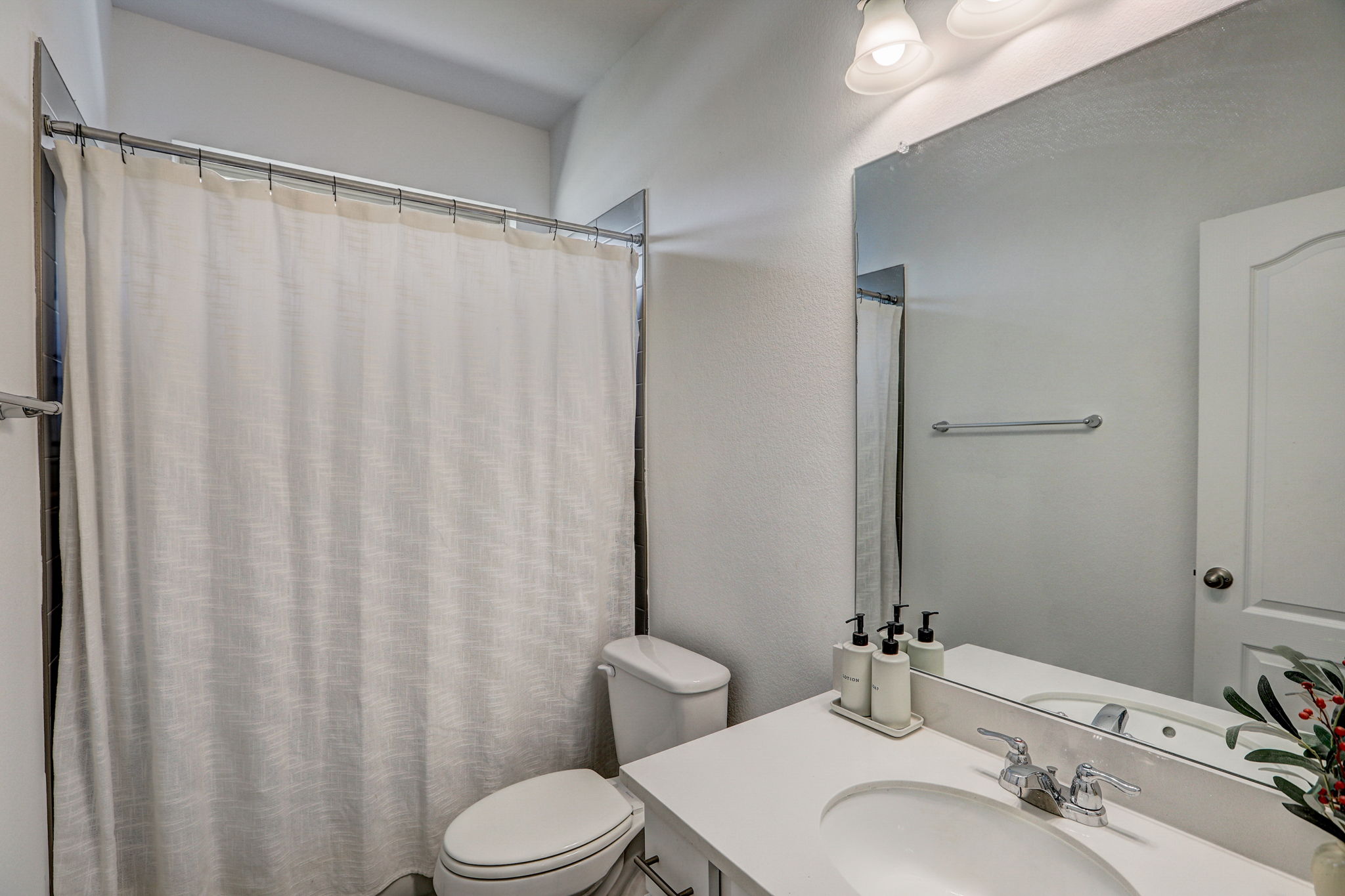 308 Monteforte Road Hutto, TX 78634 - Photo 11 of 32 a bathroom with a sink and a mirror