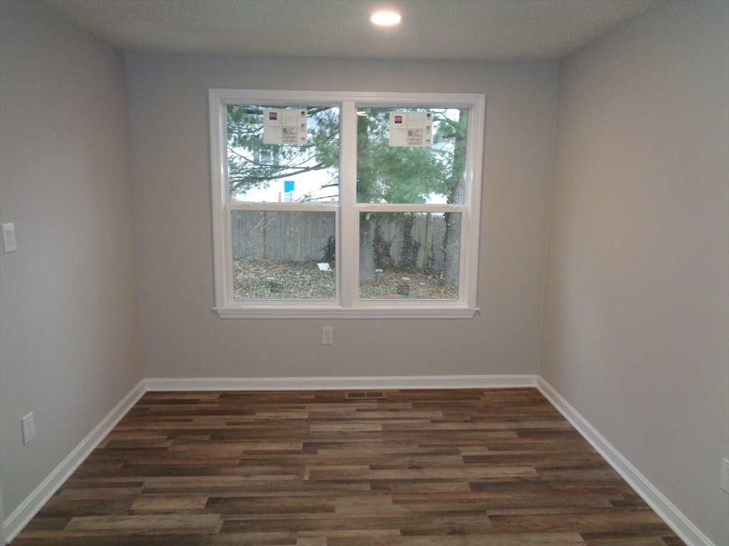 33 Hally Road Lowell, MA 01854 - Photo 9 of 19 a view of wooden floor and window in a room