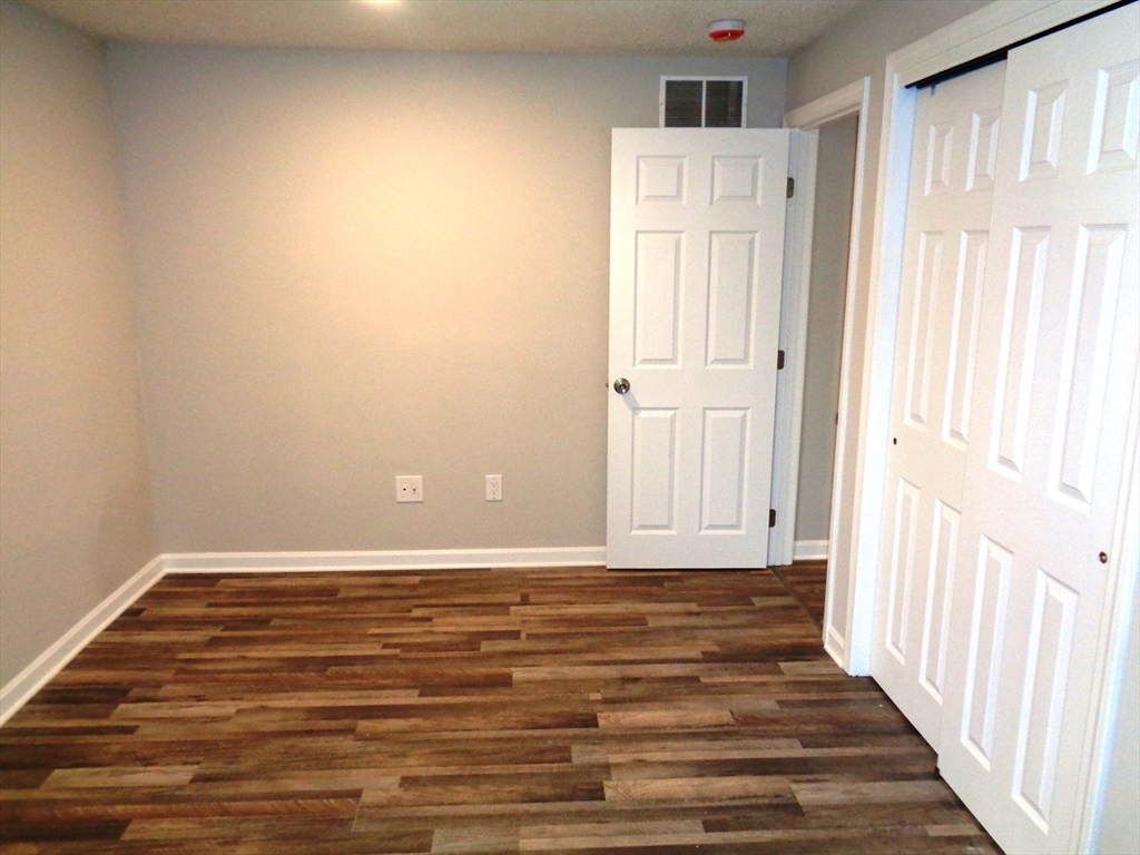 33 Hally Road Lowell, MA 01854 - Photo 10 of 19 a view of a room with wooden floor and white walls