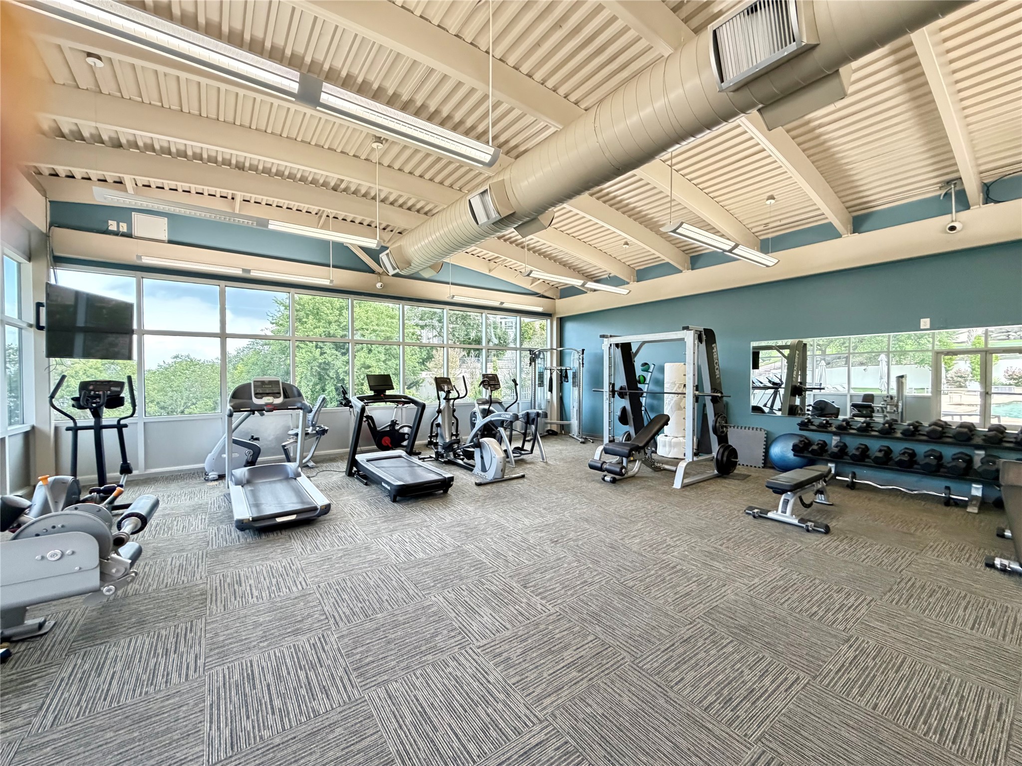 2918 Ranch Road 620 North, Unit C120 Austin, TX 78734 - Photo 31 of 34 A well-equipped fitness center offers panoramic outdoor views and modern exercise machines.
