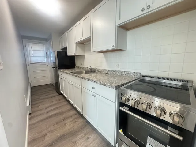 a kitchen with a stove and a sink