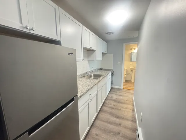 a large white kitchen with white cabinets