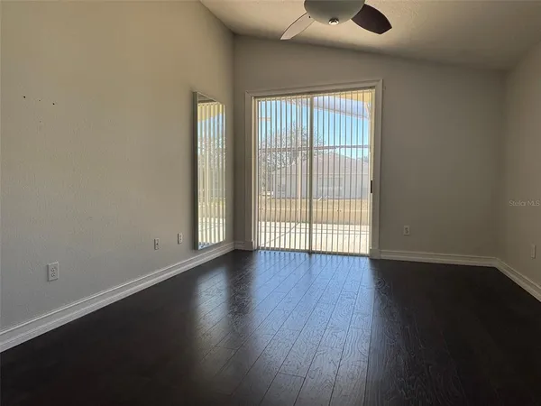 a view of an empty room with wooden floor