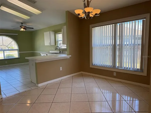 a kitchen with stainless steel appliances granite countertop a stove a sink and a window