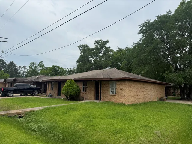 a view of a house with a yard potted plants
