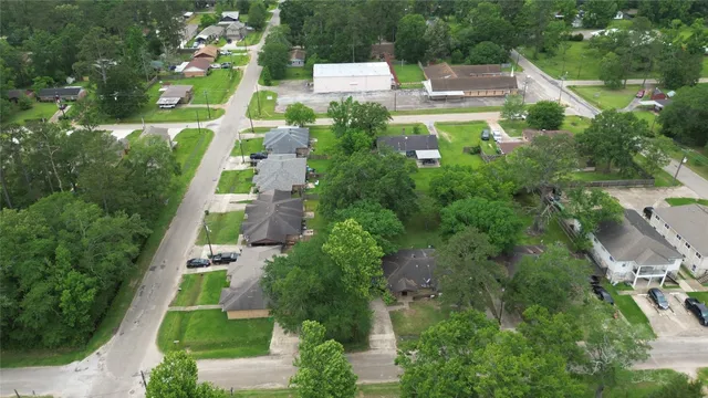 an aerial view of residential houses with outdoor space and street view