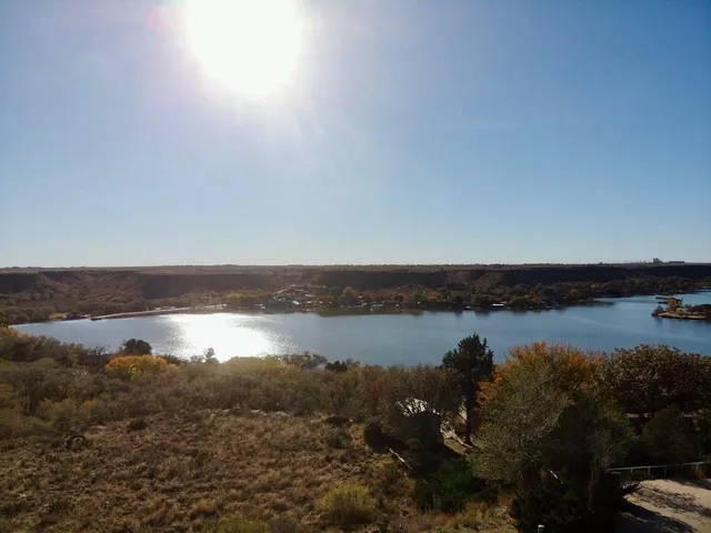 a view of a lake in middle of forest