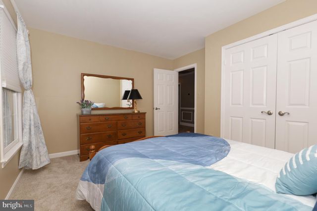 a view of a patio with couches chairs and wooden floor