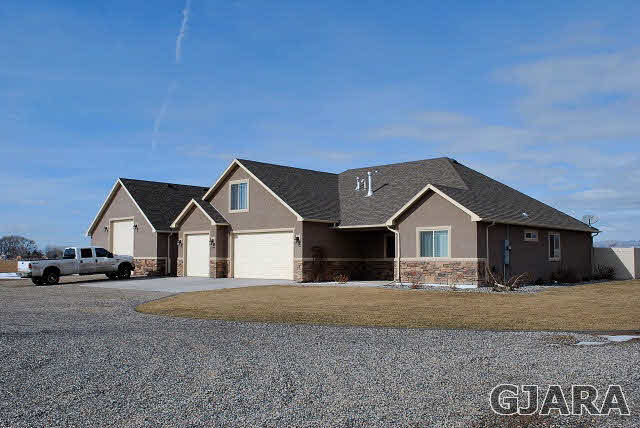 2020 Roma Avenue Fruita, CO 81521 - Photo 1 of 9 a front view of a house with a yard