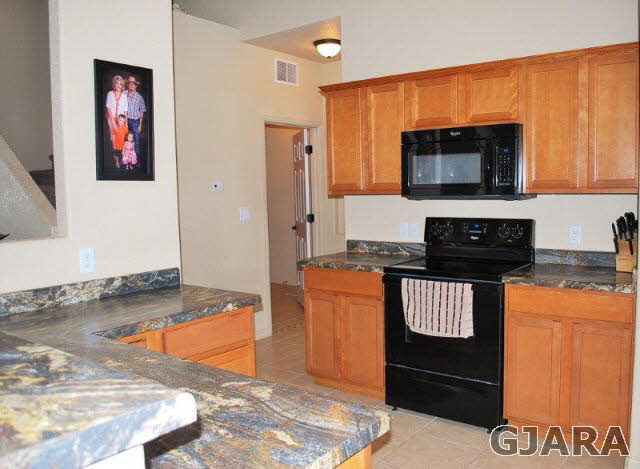 2020 Roma Avenue Fruita, CO 81521 - Photo 3 of 9 a kitchen with stainless steel appliances granite countertop a stove and a microwave