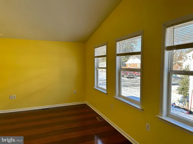 a view of a room with wooden floor and windows