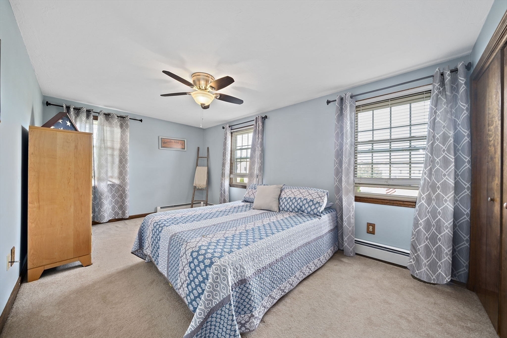164 Hancock Street Abington, MA 02351 - Photo 15 of 42 a bedroom with a bed and a chandelier