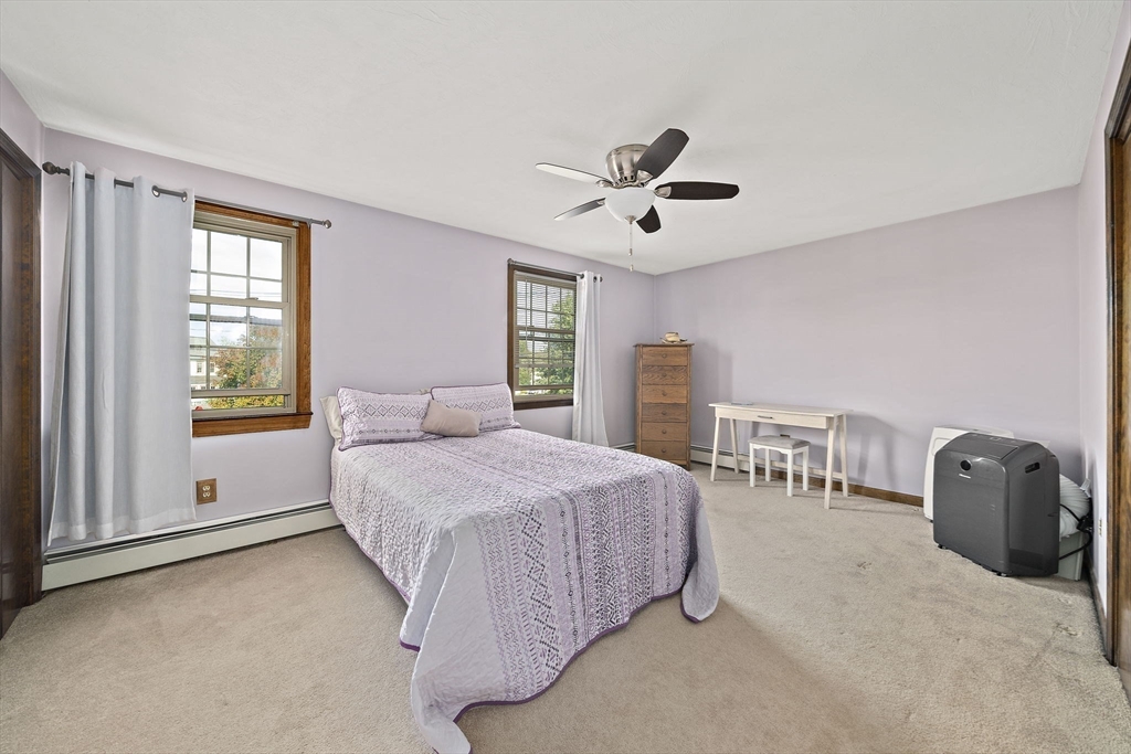 164 Hancock Street Abington, MA 02351 - Photo 16 of 42 a bedroom with a bed a chandelier and a window