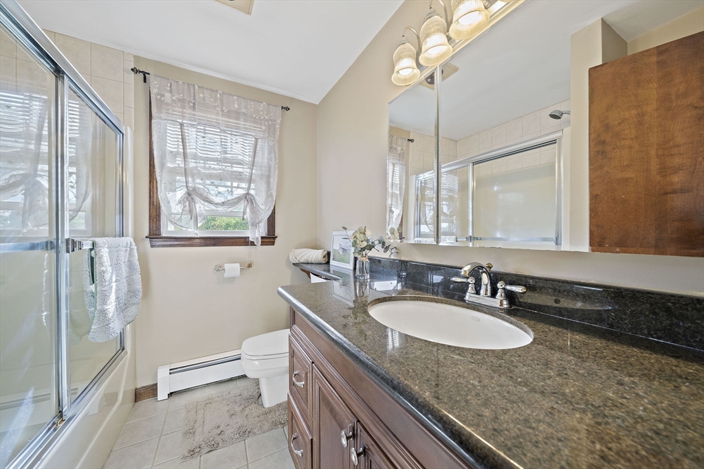 164 Hancock Street Abington, MA 02351 - Photo 18 of 42 a bathroom with a granite countertop sink and a mirror