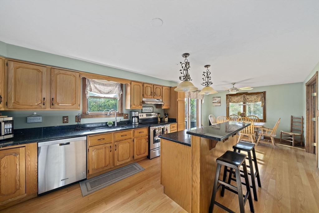 164 Hancock Street Abington, MA 02351 - Photo 4 of 42 a very nice looking kitchen with granite countertop a stove a sink a dining table and chairs