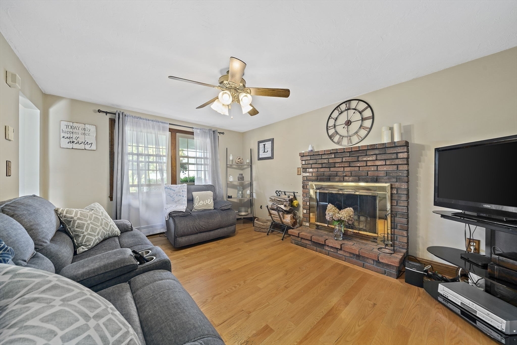 164 Hancock Street Abington, MA 02351 - Photo 8 of 42 a living room with furniture a flat screen tv and a fireplace