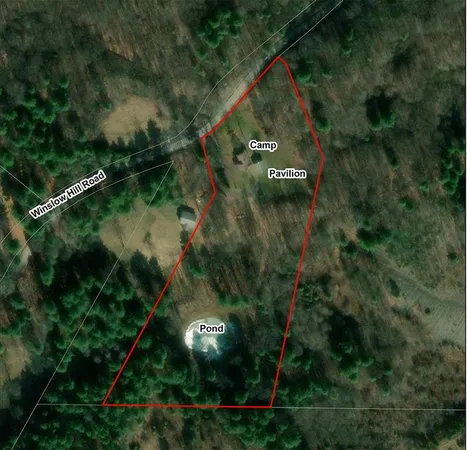 an aerial view of a residential houses with outdoor space and street view