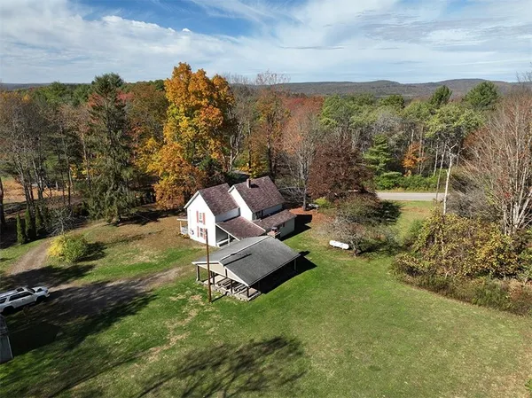 a view of a patio with chairs and a yard