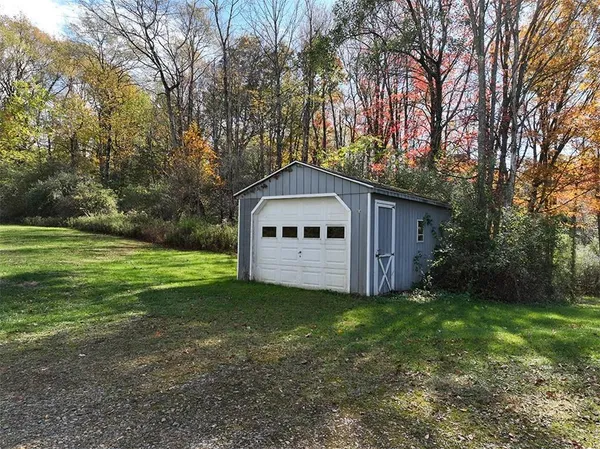 a front view of a house with yard and green space