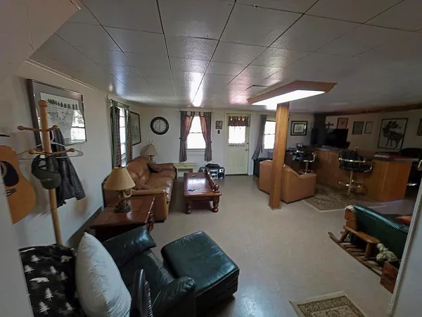 a living room with furniture a flat screen tv and gym equipment
