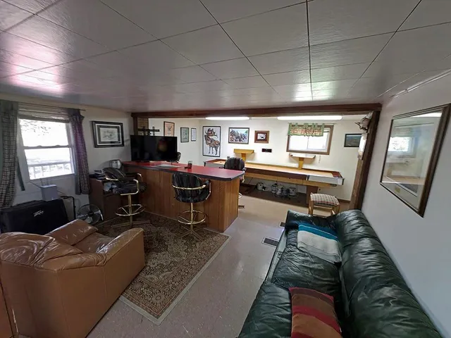 a living room with furniture and a piano
