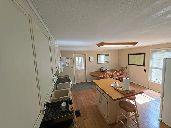 a view of a workspace with furniture and wooden floor