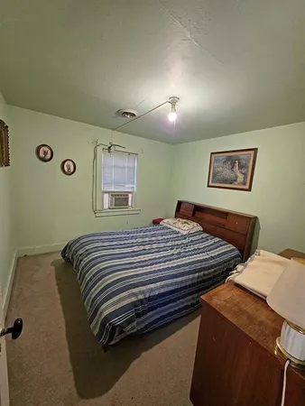 a bedroom with a bed and cabinets