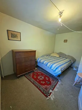 a bedroom with two beds and lamp