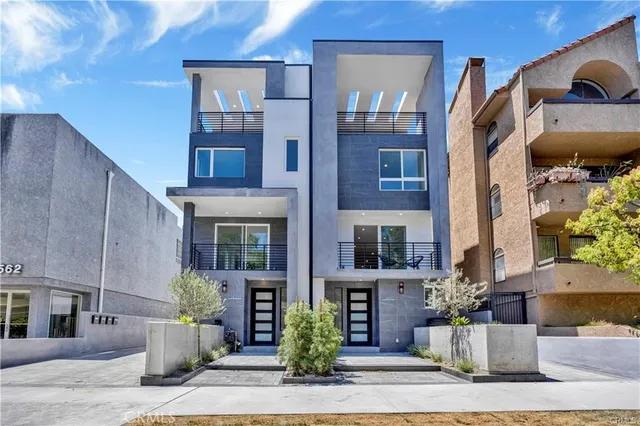 a front view of a brick house with a yard