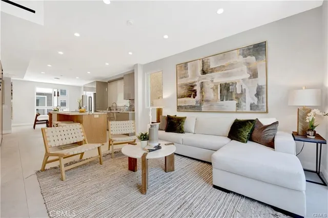 a living room with furniture and a painting on the wall