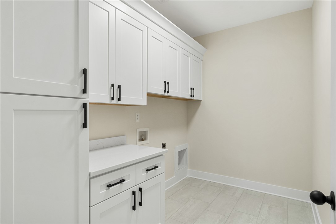 100 Garden Gate Drive Anderson, SC 29621 - Photo 34 of 43 This bright laundry area features abundant cabinetry and durable flooring for functional living.