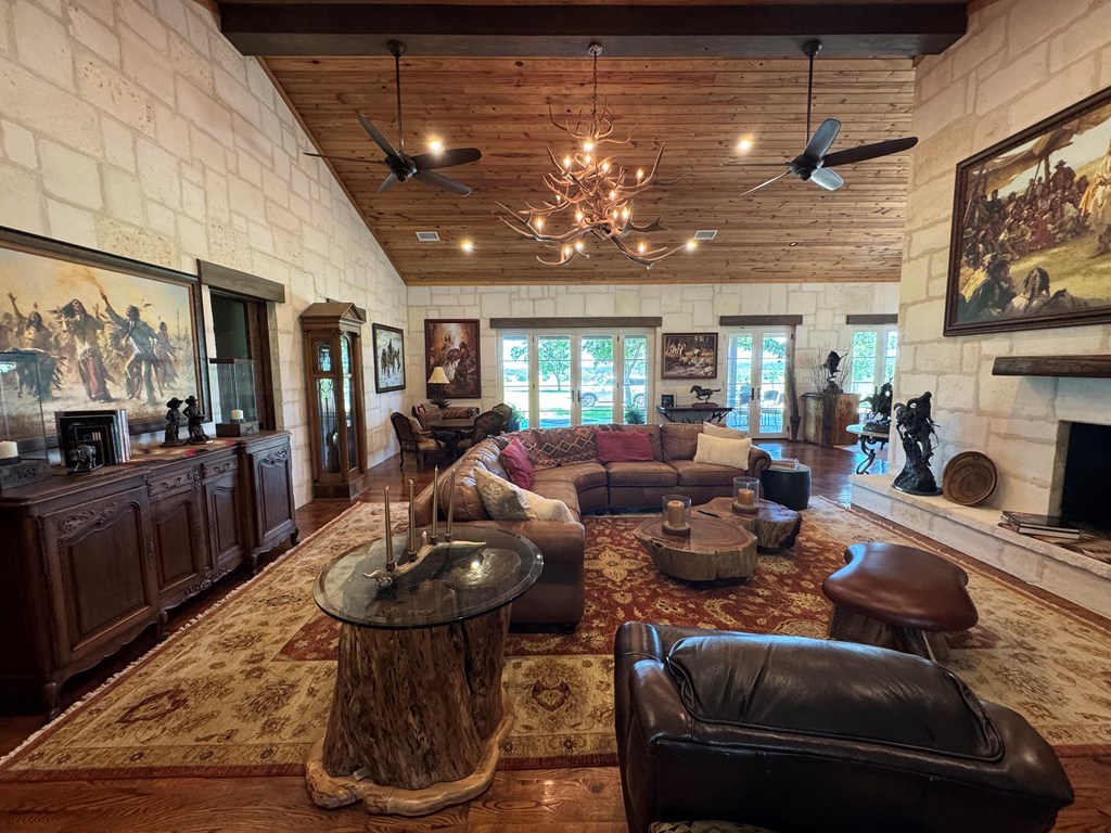 772 Luckenbach Road Fredericksburg, TX 78624 - Photo 15 of 87 a living room with furniture and a fireplace