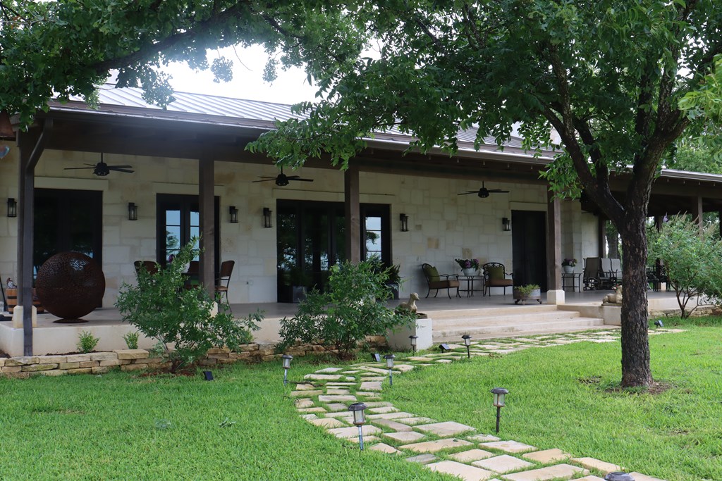 772 Luckenbach Road Fredericksburg, TX 78624 - Photo 2 of 87 a front view of a house with garden
