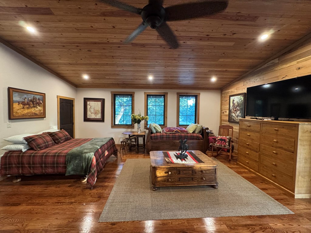 772 Luckenbach Road Fredericksburg, TX 78624 - Photo 49 of 87 a living room with furniture and a flat screen tv