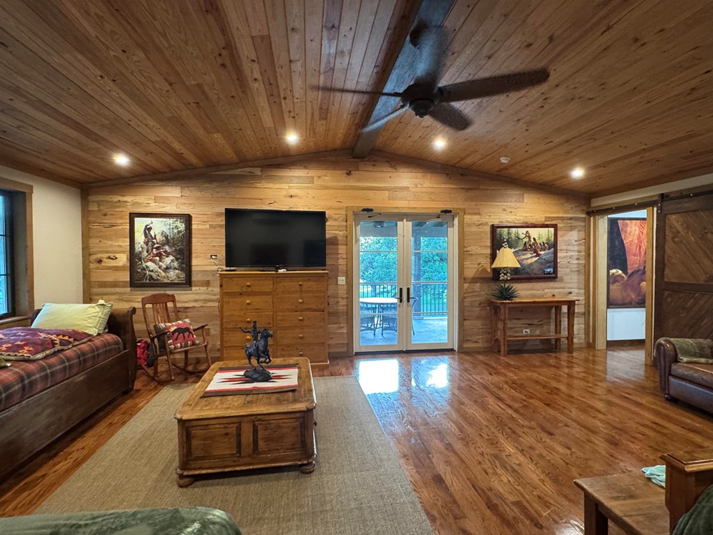 772 Luckenbach Road Fredericksburg, TX 78624 - Photo 50 of 87 a living room with furniture and a flat screen tv
