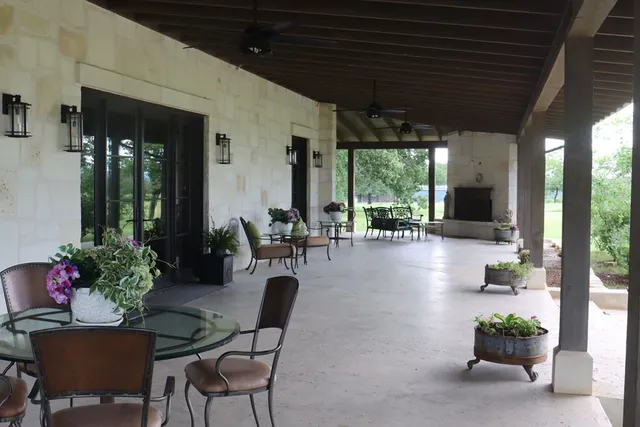 a view of a porch with furniture and a backyard