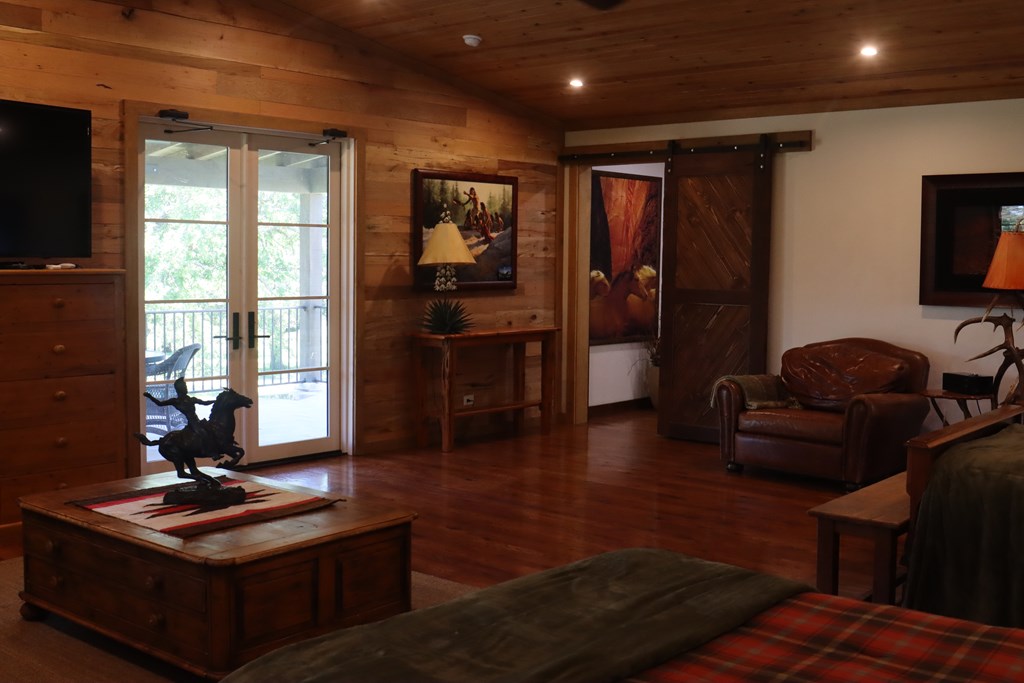 772 Luckenbach Road Fredericksburg, TX 78624 - Photo 56 of 87 a living room with furniture a flat screen tv and a window