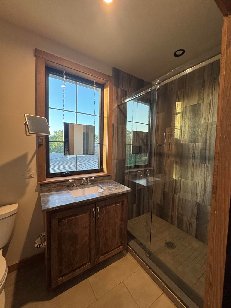 772 Luckenbach Road Fredericksburg, TX 78624 - Photo 58 of 87 a bathroom with a sink mirror and a shower