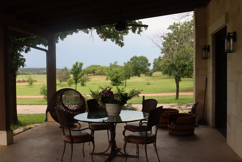 772 Luckenbach Road Fredericksburg, TX 78624 - Photo 60 of 87 a view of a porch with furniture and a yard