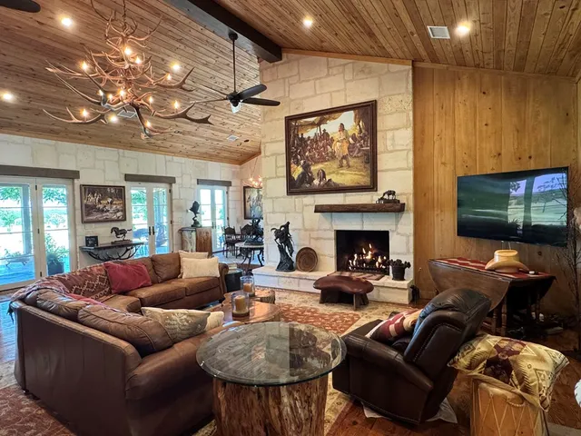 a living room with furniture a fireplace and a flat screen tv