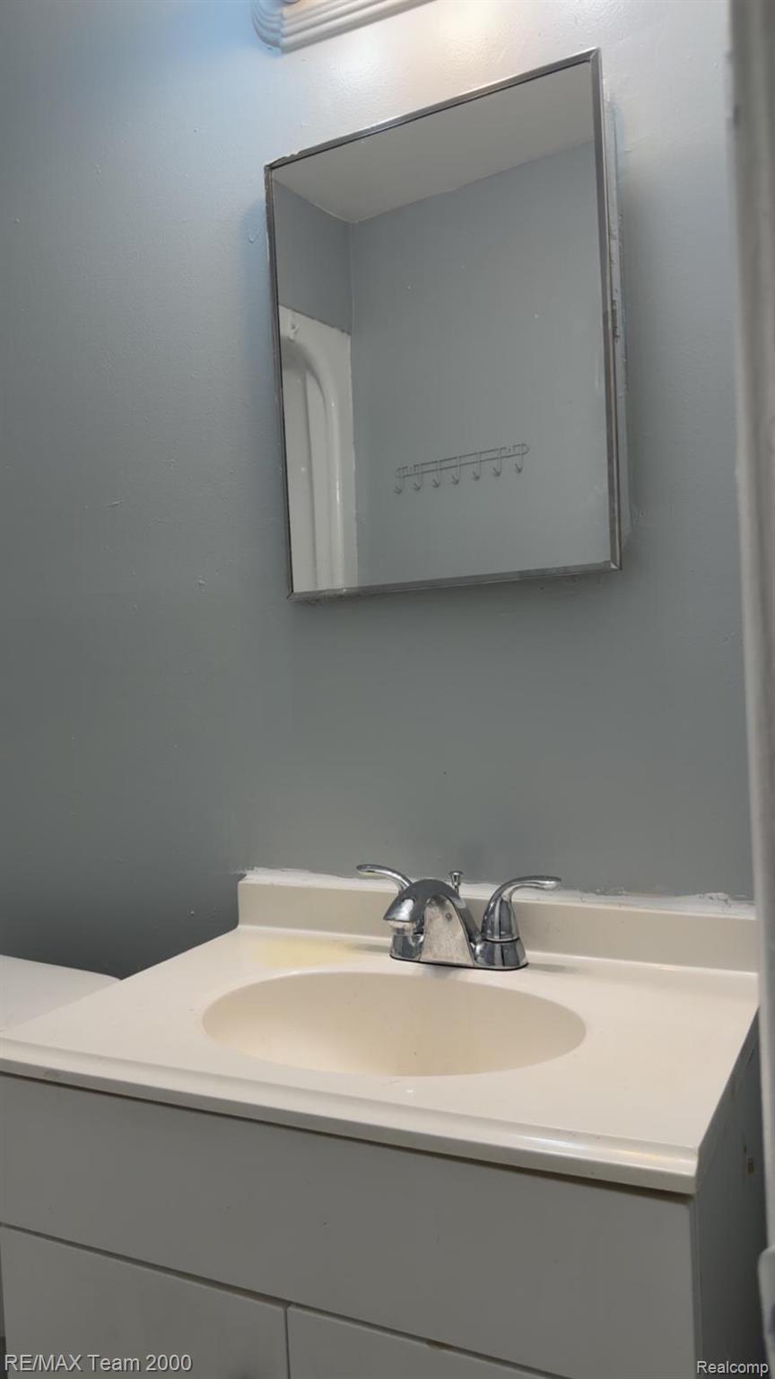 6646 Harding Street Taylor, MI 48180 - Photo 7 of 12 Vanity with an integrated sink, polished chrome faucet, and white base cabinetry