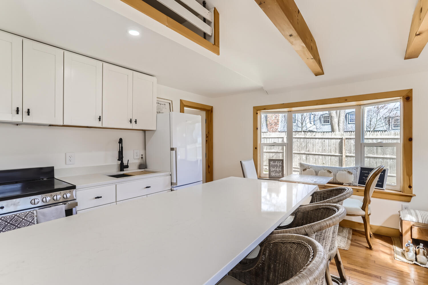 95 Summer Street Vineyard Haven, MA 02568 - Photo 10 of 23 a view of a kitchen with dining table and chairs