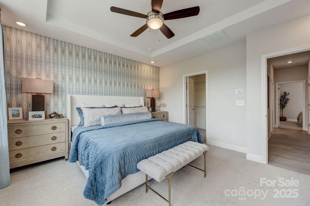 541 Annie Lowery Way Davidson, NC 28036 - Photo 20 of 29 a bedroom with a bed and a chandelier