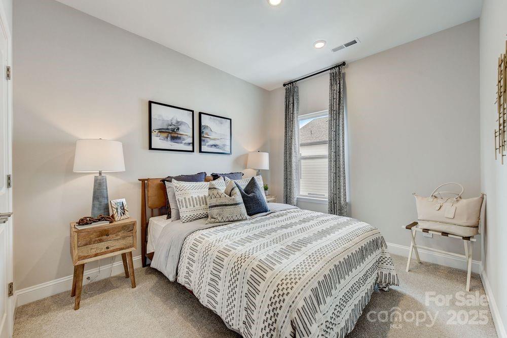 541 Annie Lowery Way Davidson, NC 28036 - Photo 25 of 29 a bedroom with a bed and a lamp on table