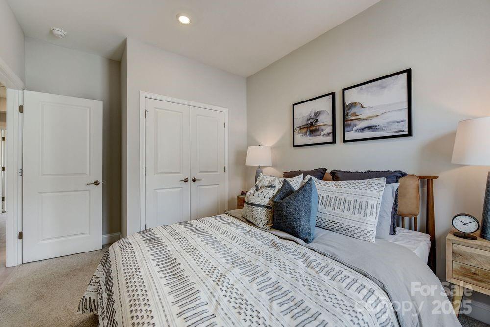 541 Annie Lowery Way Davidson, NC 28036 - Photo 26 of 29 a bedroom with a large bed and a painting on the wall