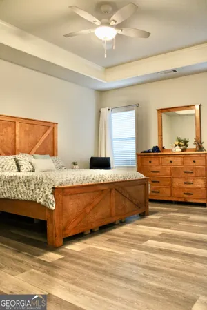 a living room with a bed and dresser