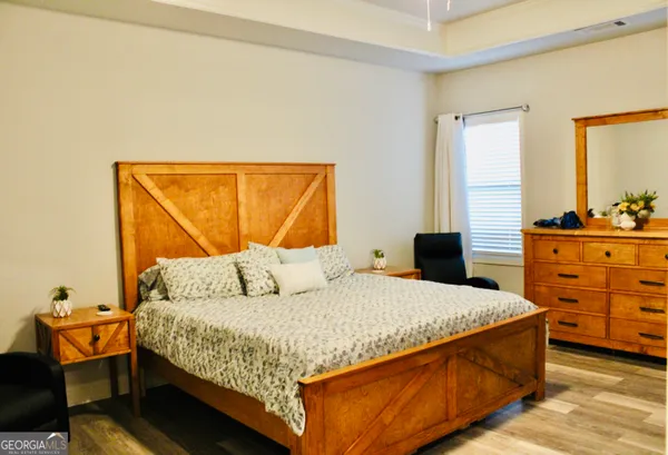 a bedroom with a bed and window