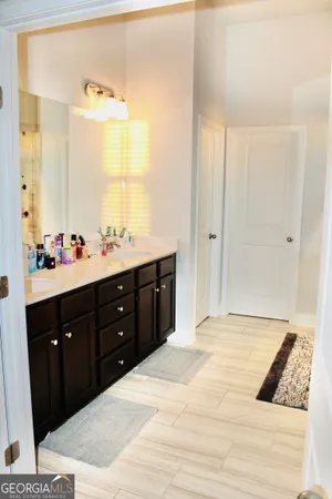 a bathroom with a double vanity sink and mirror