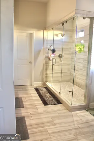 a bathroom with a glass shower door and a bathtub